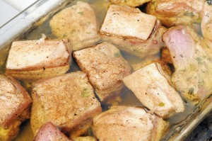 The cubes of pork belly are submerged in a bath of pork fat and slowly cooked.